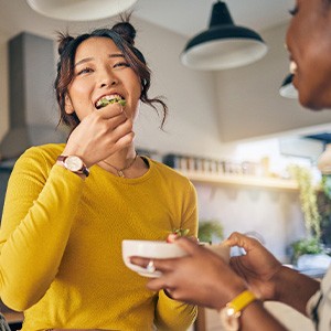 Woman in yellow shirt enjoying salad with friends