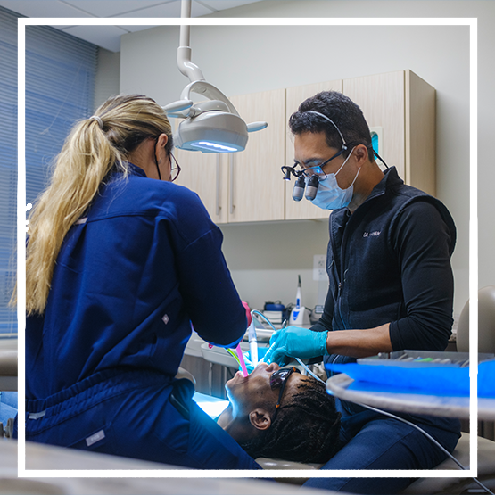 Woman in professional attire pointing to her wristwatch