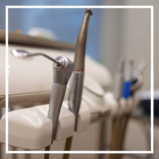 Row of handheld dental devices in a treatment room