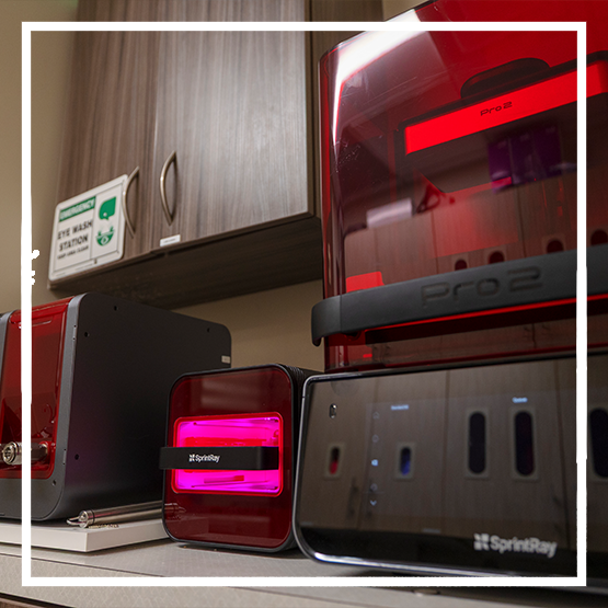 3D printer creating a model of a row of teeth