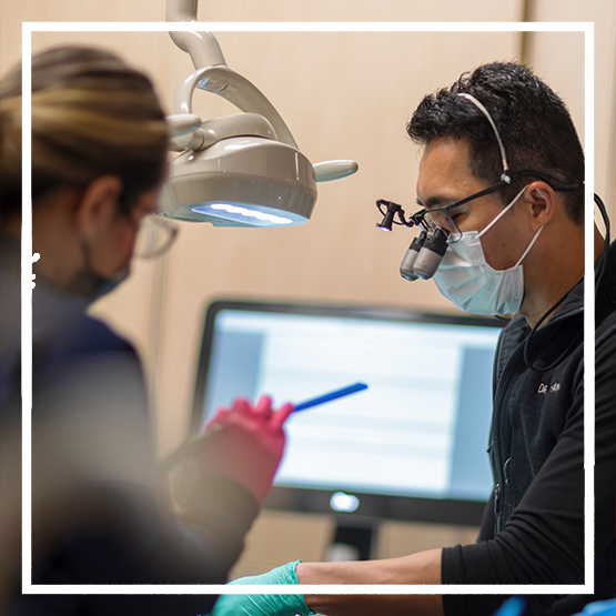 Illustration of two dental implants being placed in the lower jaw