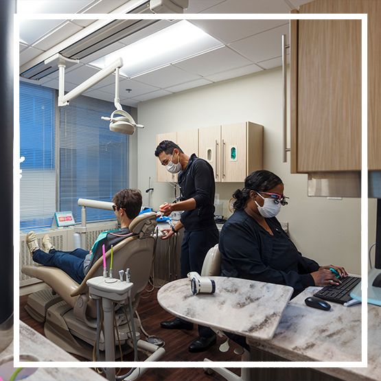 Dental hygienist cleaning a patient's teeth