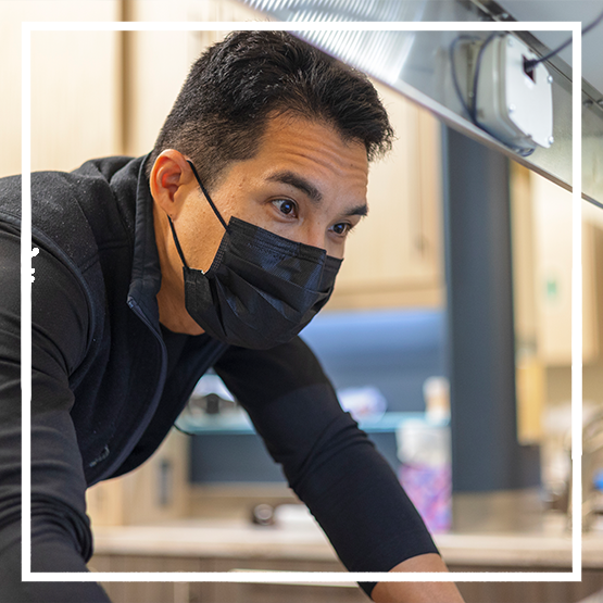 Jar filled with coins next to three small stacks of coins