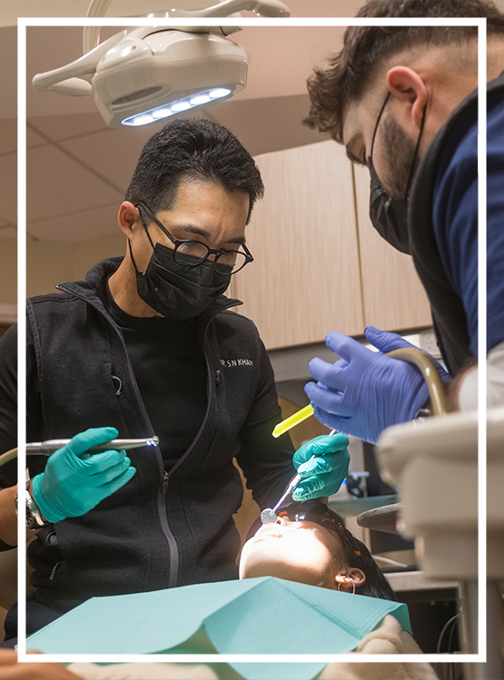 Brunette woman smiling after receiving dental services in Washington DC