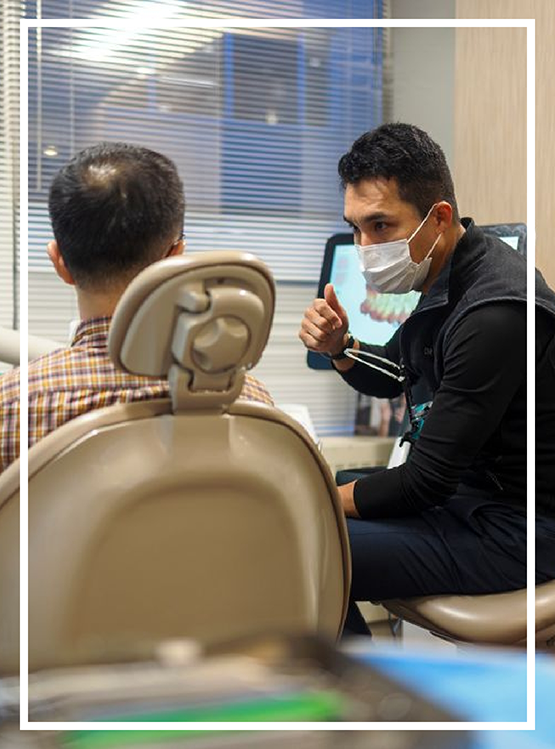 Doctor Kham talking to a dental patient