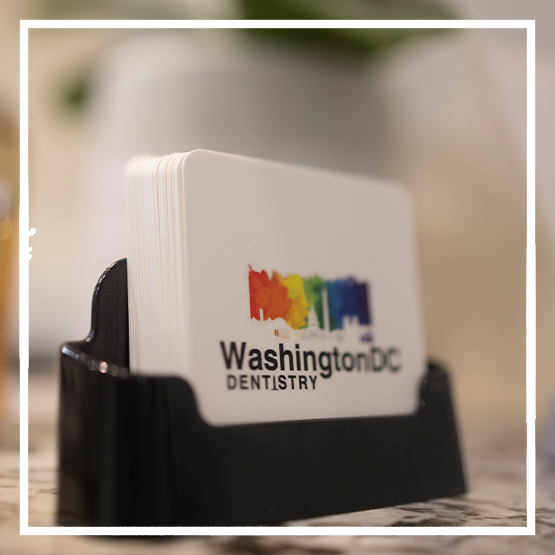 Dental team member handing a clipboard to a patient