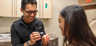 Three women laughing together outdoors