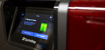 Blonde woman touching her face and smiling while looking back over her shoulder