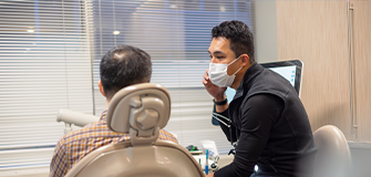 Man holding the side of his jaw in pain