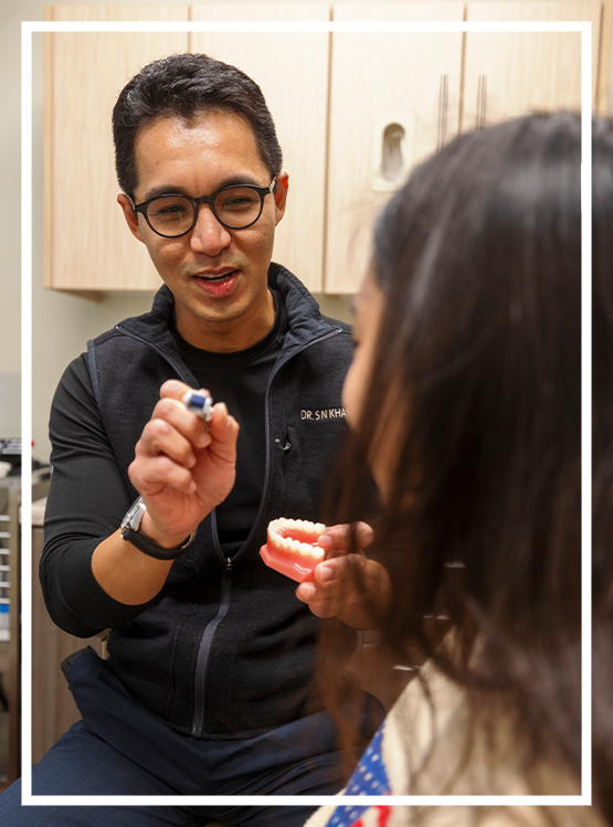 Dental team member showing a patient x rays of their tooth