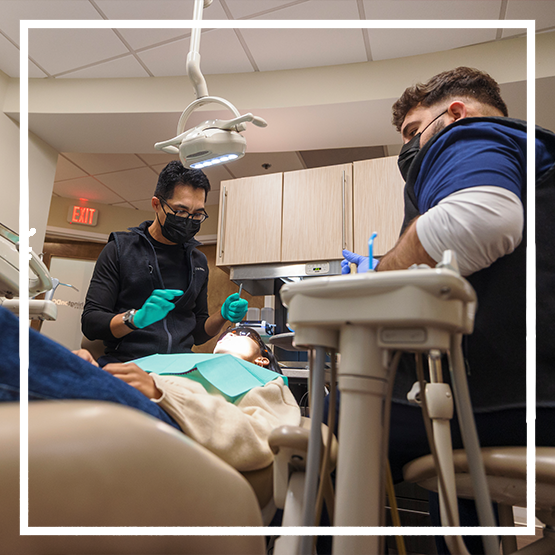 Child in the dental chair getting fluoride applied to their teeth